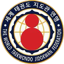 Jidokwon TaeKwonDo symbol featuring the Daruma figure surrounded by lotus petals