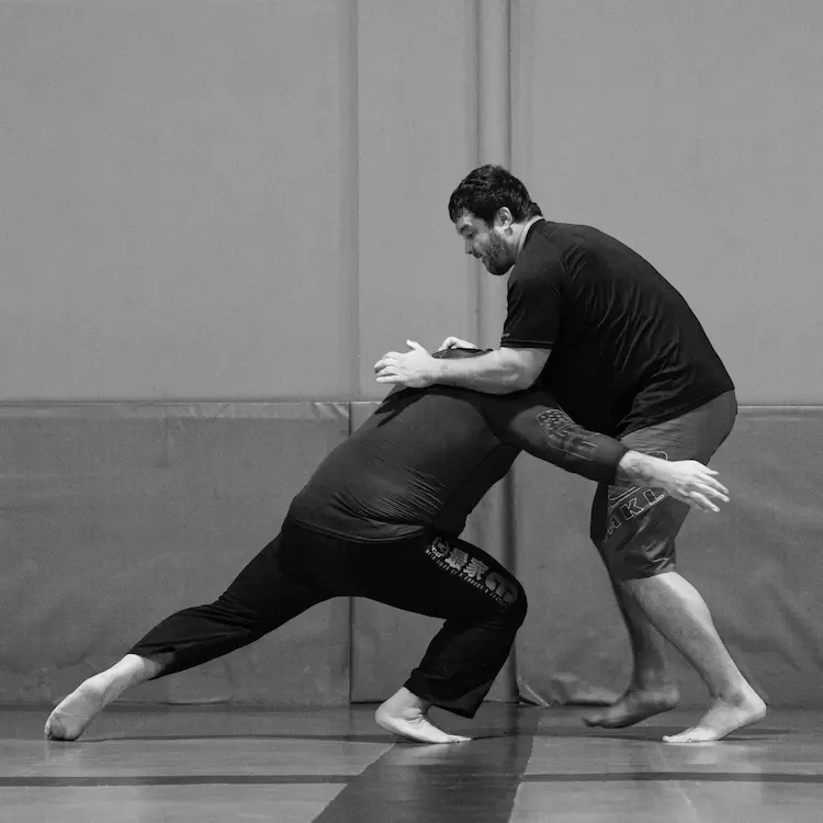 Brazilian Jiu Jitsu grappling exchange showing close-range ground control for self defense