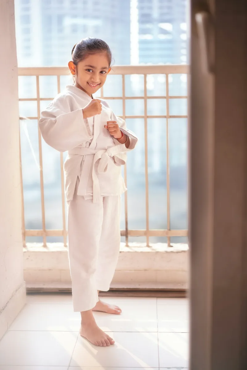 Kids practicing martial arts kicks together during a youth training class