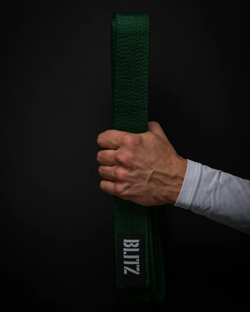 Close-up of a BJJ belt showing the ranking stripe system