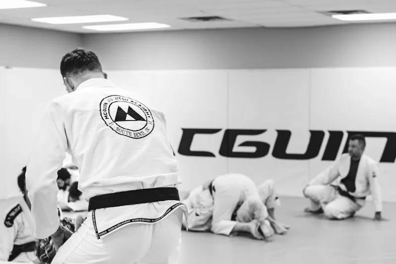 BJJ practitioners training in gi uniforms at a martial arts academy, continuing the Gracie Jiu Jitsu tradition