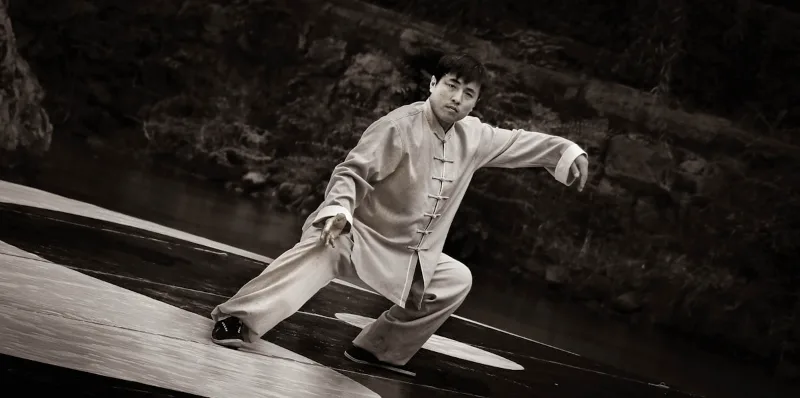 Tai chi practitioner demonstrating foundational form with proper stance