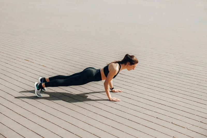 Person doing bodyweight conditioning exercises in a beginner martial arts workout