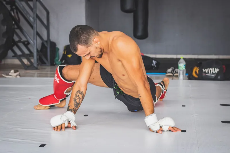 Athlete stretching during a martial arts workout warm up for beginners