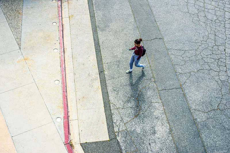 Woman walking alert on a city street practicing situational awareness for personal safety