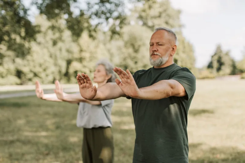 Tai chi meditation practiced as slow flowing movement outdoors at sunrise