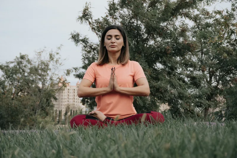 Yoga practitioner in seated meditation pose practicing breathwork and mindfulness