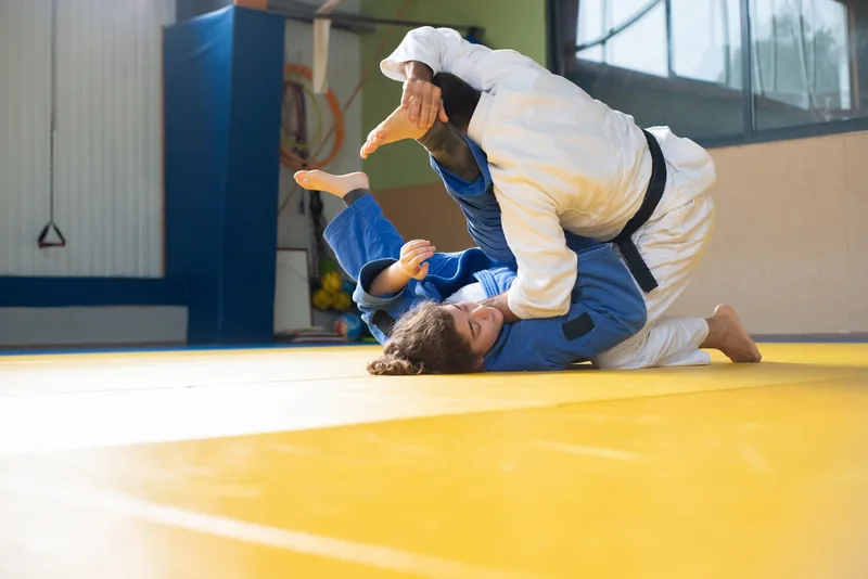 Judo athletes executing a standing throw, showing the throwing focus in judo vs jiu jitsu