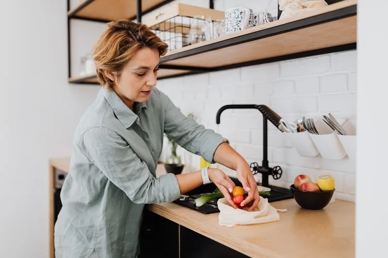 Woman preparing fresh fruit and vegetables, pairing nutrition with tai chi for weight loss