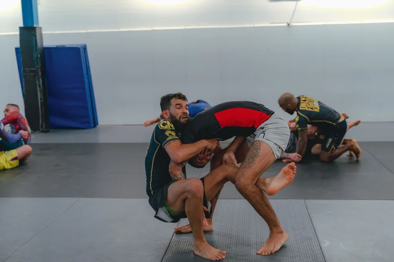 Training partners rolling live on the mat, where the mental benefits of BJJ training are built
