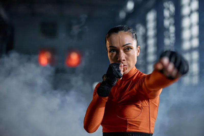 Woman practicing a strike during womens self defense training to create distance and escape