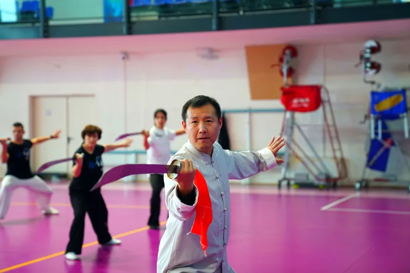 Chinese martial arts class practicing a weapons form — the final stage of the Wing Chun forms curriculum