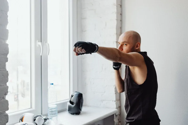 Martial artist throwing a straight punch with the rear hand guarding the centerline — the structure behind the Wing Chun chain punch