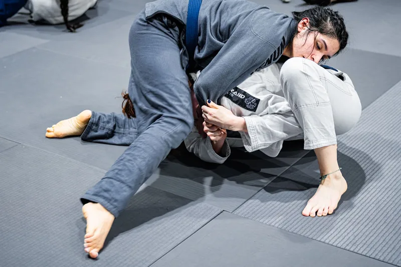 Two BJJ students rolling on the mat, fueled by a jiu jitsu nutrition plan