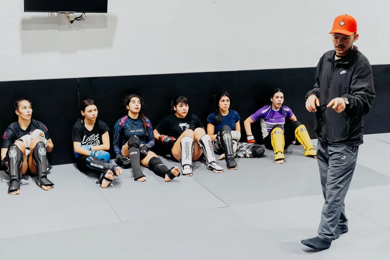 Instructor teaching ground control as part of jiu jitsu self defense training
