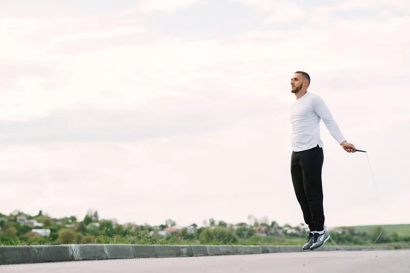 Man skipping rope in interval training, a staple of MMA fat loss conditioning