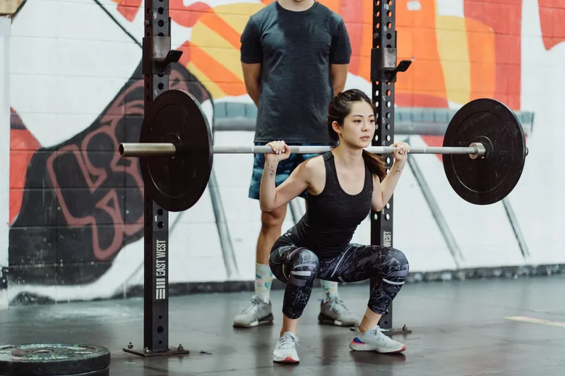 Athlete lifting a loaded barbell as part of an MMA strength and conditioning program
