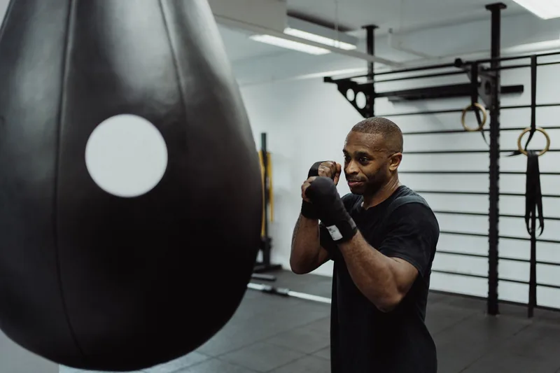 Fighter working the speed bag as part of a beginner MMA conditioning routine