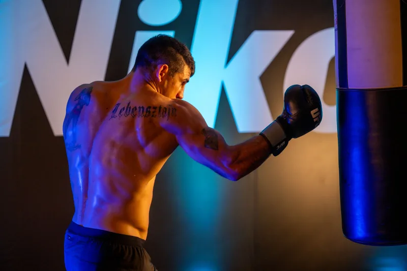 MMA fighter training on a heavy bag, showing the multi-discipline striking used in mixed martial arts