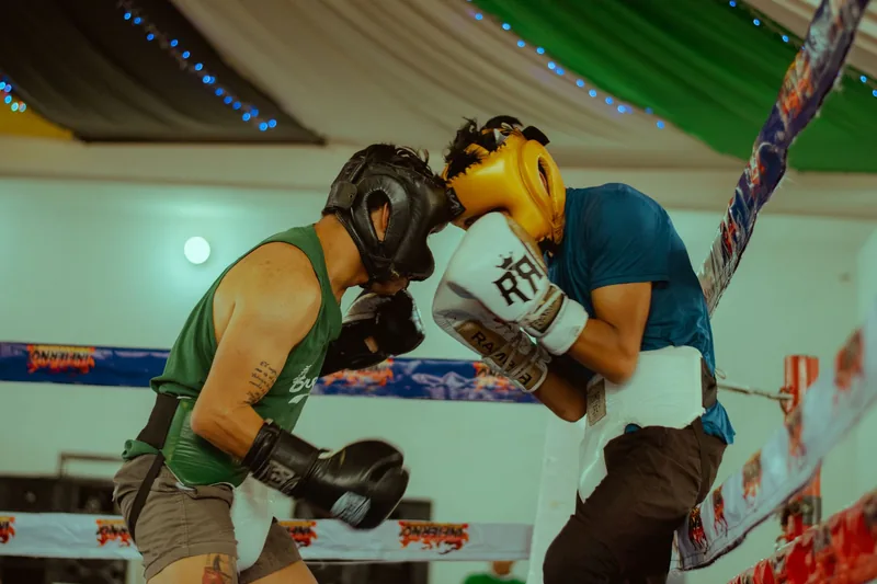 Fighters sparring in protective gear, comparing MMA vs boxing vs karate under different rulesets